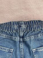 شلوار جین زنانه شافل آبی با سنگشور سبز سایز بزرگ